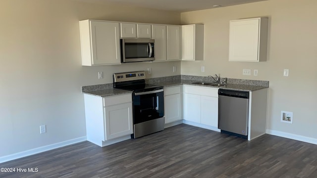 kitchen featuring white cabinetry, sink, stainless steel appliances, and dark hardwood / wood-style floors