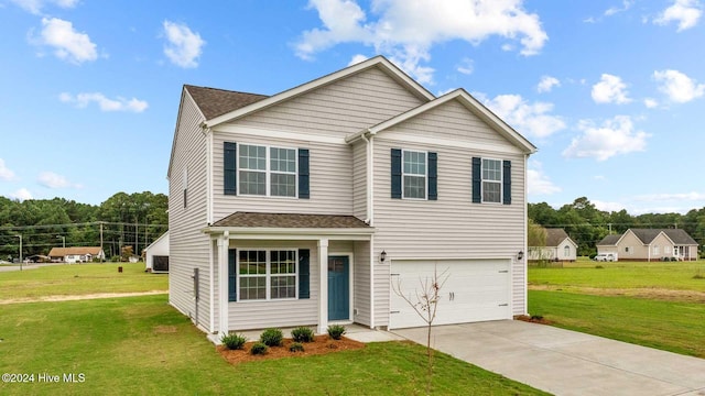 view of front of home with a front yard and a garage