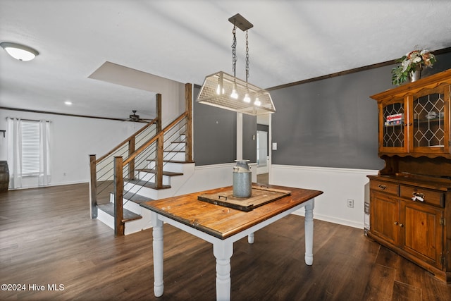 dining area featuring ceiling fan, dark wood-type flooring, and ornamental molding