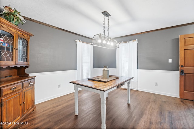 dining room featuring dark hardwood / wood-style floors and ornamental molding