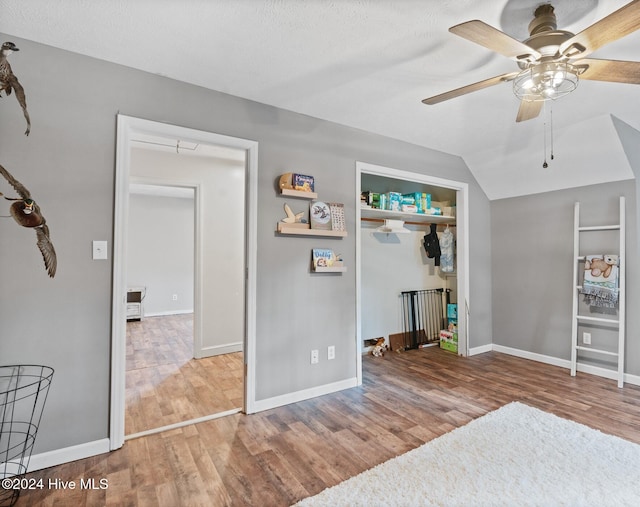 unfurnished bedroom with a closet, ceiling fan, hardwood / wood-style floors, and a textured ceiling