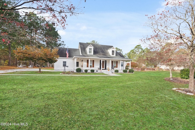 cape cod home featuring a front lawn and covered porch