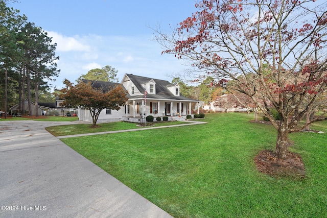 cape cod house with a porch and a front yard