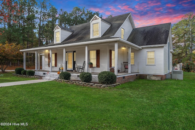 view of front of home with a lawn and a porch