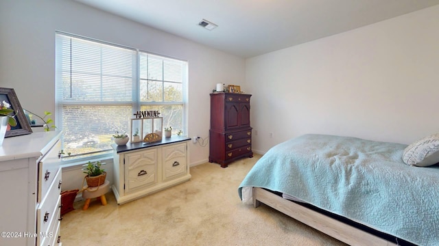 bedroom featuring light carpet