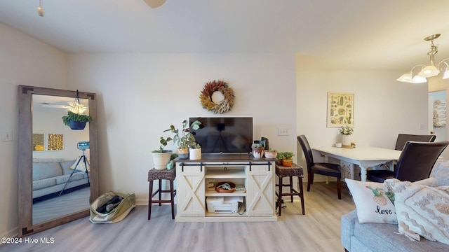 living room with hardwood / wood-style flooring and a notable chandelier