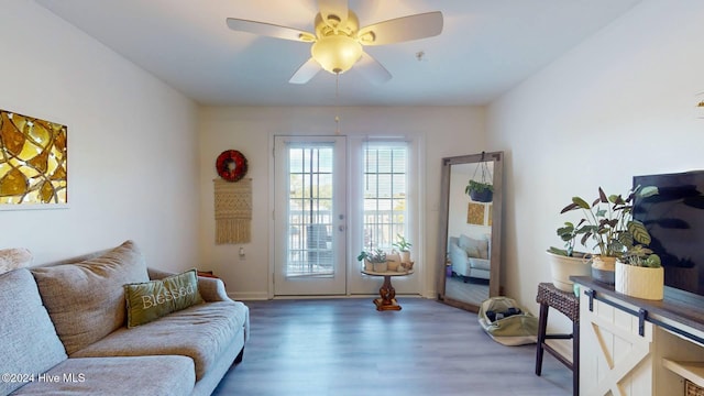 living room featuring hardwood / wood-style flooring, ceiling fan, and french doors