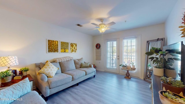 living room with dark hardwood / wood-style floors and ceiling fan