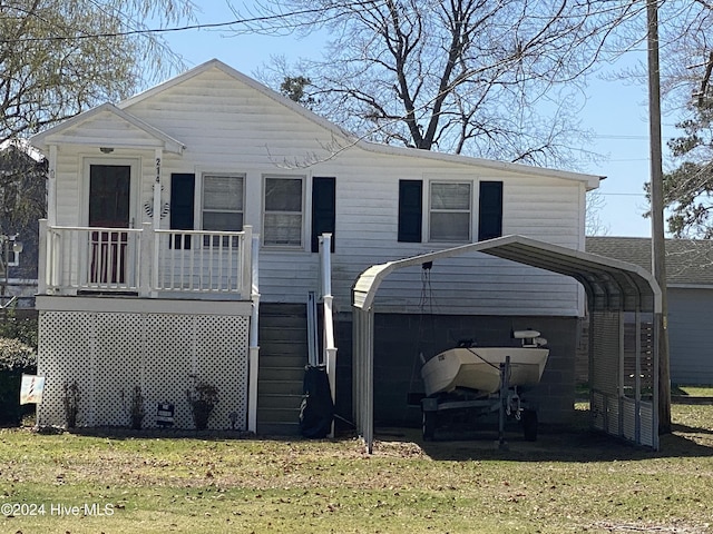 view of front of home featuring a porch, a front yard, and a garage