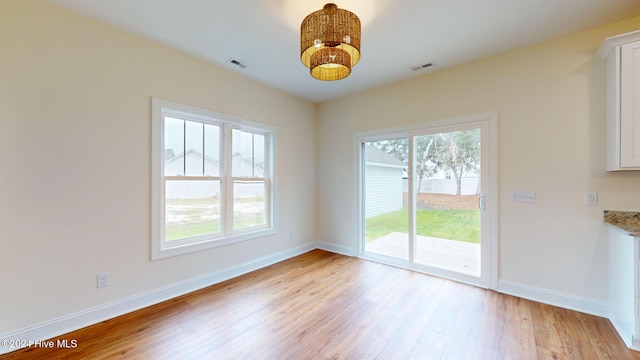 unfurnished dining area featuring light hardwood / wood-style floors