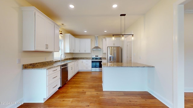 kitchen with white cabinets, stainless steel appliances, light hardwood / wood-style floors, and sink