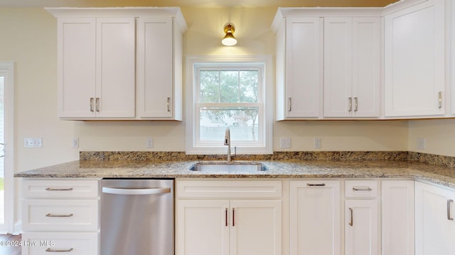 kitchen featuring dishwasher, white cabinetry, and sink