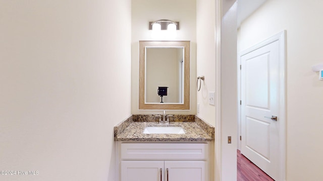 bathroom with hardwood / wood-style floors and vanity