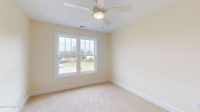 carpeted empty room featuring ceiling fan