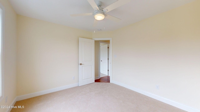 spare room with ceiling fan and carpet floors