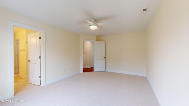 unfurnished bedroom with ceiling fan and light colored carpet