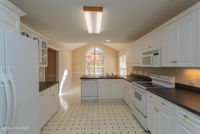 kitchen featuring white cabinetry, sink, kitchen peninsula, vaulted ceiling, and white appliances