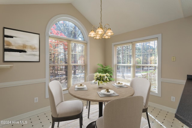 dining room featuring a chandelier, light tile patterned floors, a wealth of natural light, and lofted ceiling