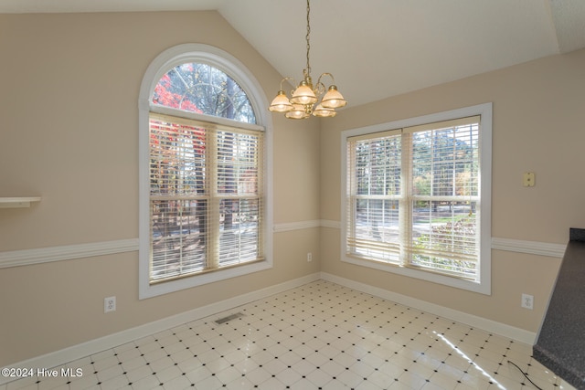 unfurnished dining area featuring a wealth of natural light, lofted ceiling, and an inviting chandelier