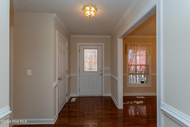 entryway with a textured ceiling, dark hardwood / wood-style flooring, and ornamental molding