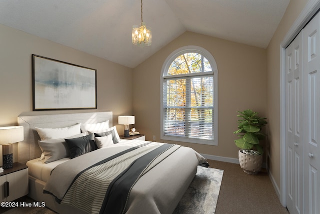 bedroom with carpet flooring, an inviting chandelier, vaulted ceiling, and a closet