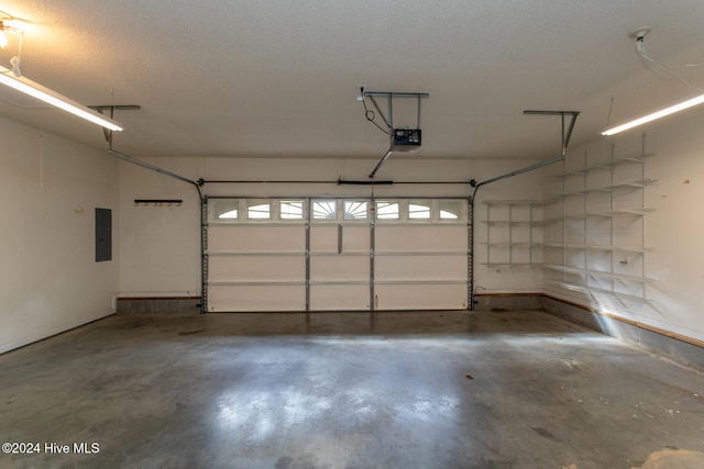 garage featuring electric panel and a garage door opener