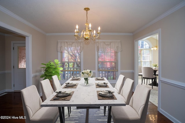 dining room with a textured ceiling, an inviting chandelier, dark wood-type flooring, and crown molding