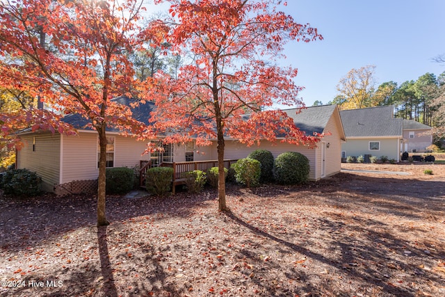 rear view of property featuring a deck