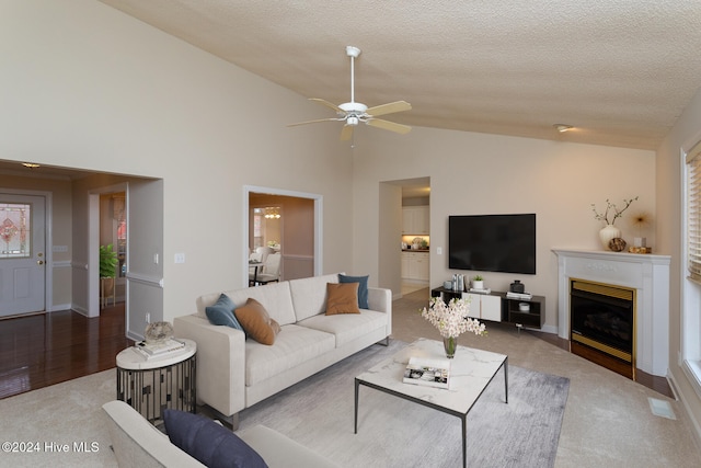 living room featuring a textured ceiling, hardwood / wood-style flooring, high vaulted ceiling, and ceiling fan