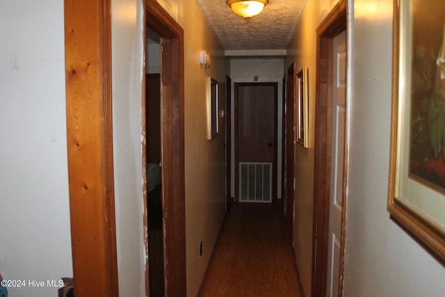 corridor with hardwood / wood-style flooring