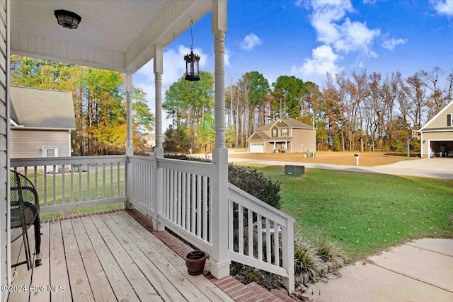 deck featuring covered porch and a yard