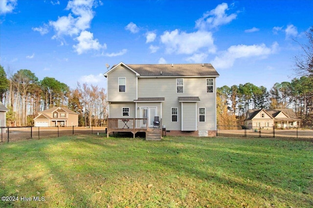 back of property featuring a lawn and a wooden deck