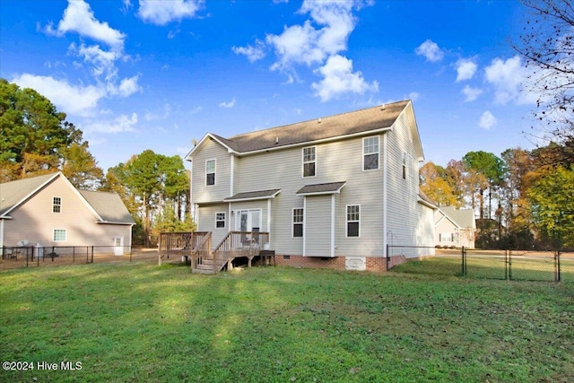 rear view of property featuring a yard and a deck