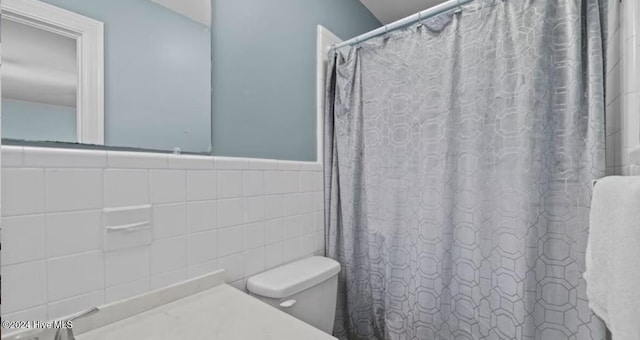 2306 Charles Blvd, Greenville, NC 27858 - bathroom featuring toilet, a shower with shower curtain, tile walls, and vanity