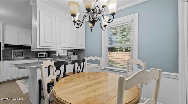 2306 Charles Blvd, Greenville, NC 27858 - dining space with a chandelier, crown molding, baseboards, and light tile patterned floors