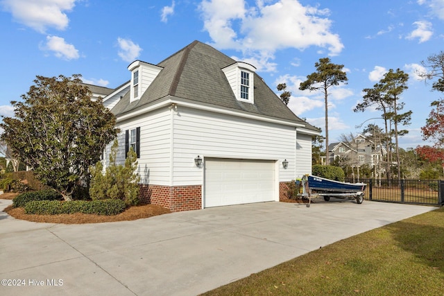 1502 Marsh Pointe, Morehead City, NC 28557 - view of side of property with concrete driveway, a shingled roof, and brick siding
