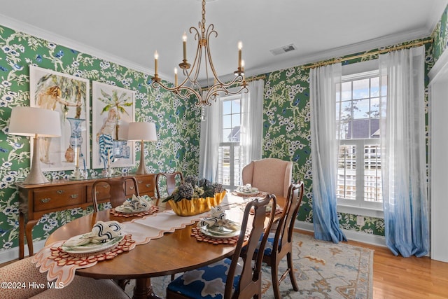 1502 Marsh Pointe, Morehead City, NC 28557 - dining area featuring wallpapered walls, crown molding, a chandelier, and wood finished floors