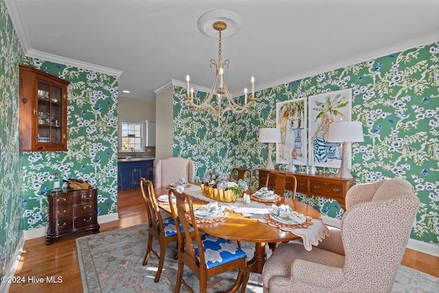 1502 Marsh Pointe, Morehead City, NC 28557 - dining area with wallpapered walls, crown molding, wood finished floors, and a chandelier