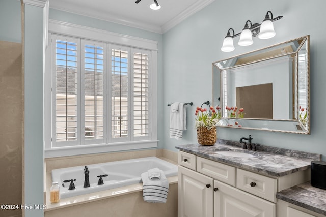 bathroom with plenty of natural light, ornamental molding, a tub, and vanity