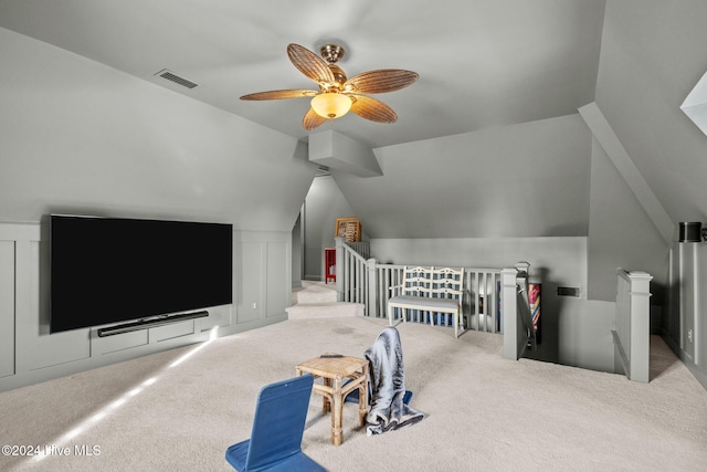 interior space with carpet flooring, ceiling fan, and lofted ceiling