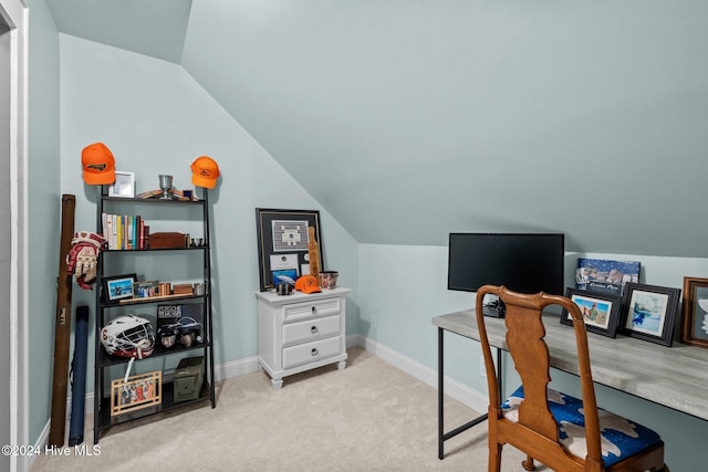 carpeted office with lofted ceiling