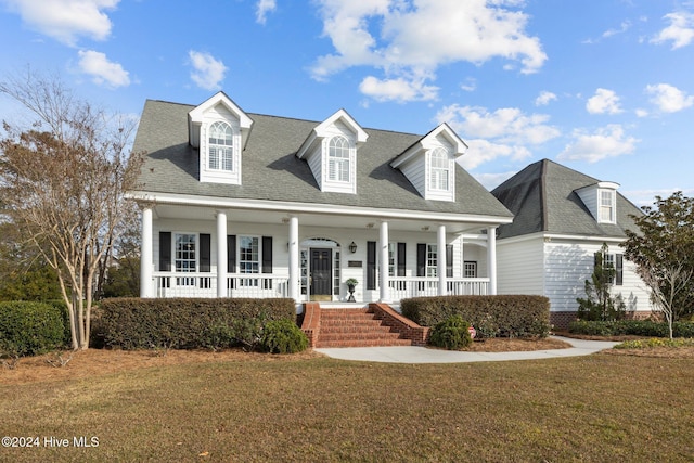 1502 Marsh Pointe, Morehead City, NC 28557 - cape cod home with covered porch, a front lawn, and roof with shingles