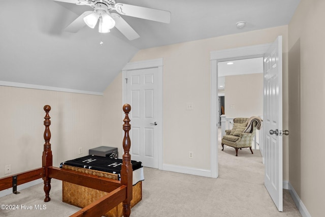 carpeted office space featuring vaulted ceiling and ceiling fan