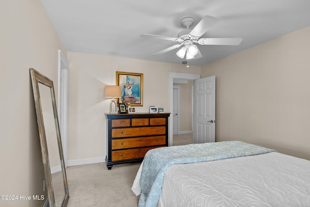 bedroom with ceiling fan and light colored carpet