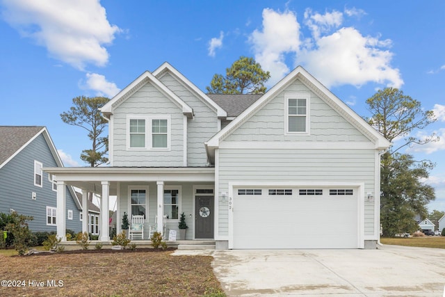 view of front of property with covered porch and a garage