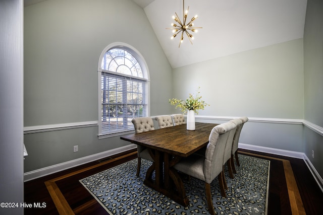 dining space with dark hardwood / wood-style floors, high vaulted ceiling, and an inviting chandelier