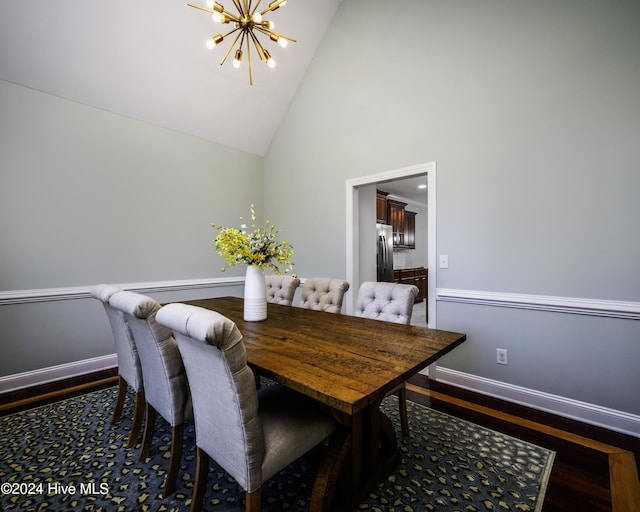 dining area featuring a chandelier, high vaulted ceiling, and dark wood-type flooring