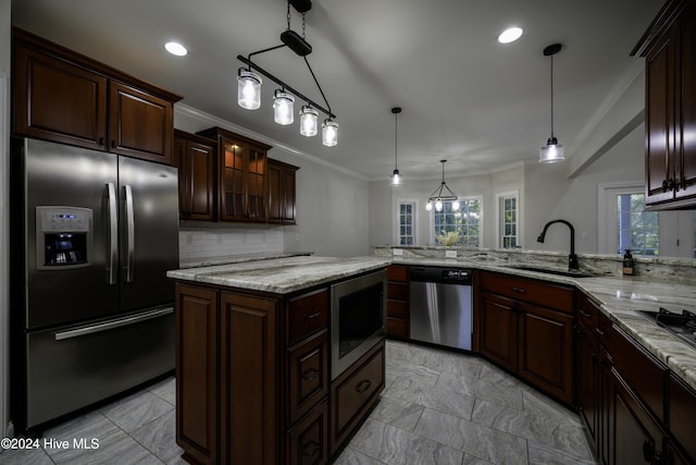 kitchen with kitchen peninsula, dark brown cabinetry, stainless steel appliances, sink, and decorative light fixtures