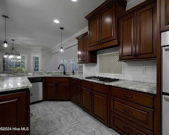 kitchen with kitchen peninsula, decorative backsplash, stainless steel appliances, sink, and decorative light fixtures