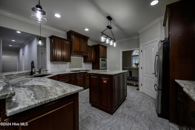 kitchen featuring sink, a center island, decorative light fixtures, dark brown cabinets, and appliances with stainless steel finishes